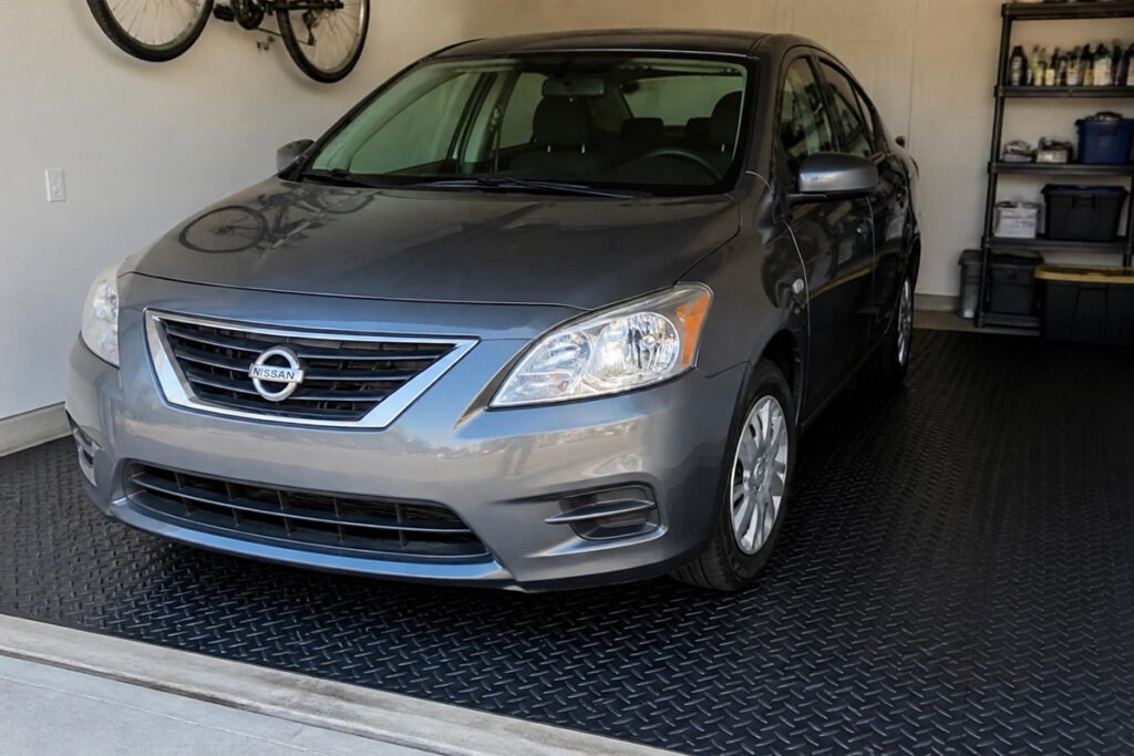 NarwooAuto budget PVC roll mat under a car in a modest single-car garage