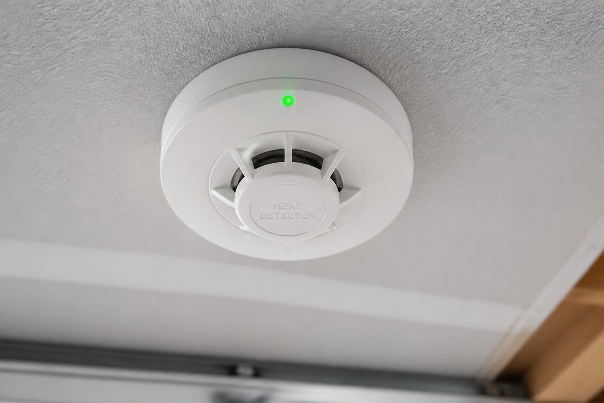 A standard smoke detector is the wrong tool for a garage — dust, vehicle exhaust, and temperature swings trigger enough false alarms that most people eventually just disable the unit, which defeats the purpose entirely. A heat detector solves that by responding to actual temperature change instead of airborne particles. For related garage fire and safety context, see our carbon monoxide and garage safety guide. This roundup focuses specifically on which heat detector to buy. Quick answer: for most attached garages, a hardwired, interconnectable unit like the First Alert HD6135FB is the most reliable choice, since it ties into your home's existing smoke/CO alarm system rather than operating as an isolated device. If wiring isn't an option or you want app alerts when you're not home, a smart or wireless model further down this list covers that instead. We compared products on detection method (fixed temperature vs. rate-of-rise), operating temperature range, interconnection capability, installation type, and price — specifically for garage use, where dust, exhaust, and wide temperature swings rule out options that work fine in a bedroom or hallway. [IMAGE 1 — THUMBNAIL: heat detector mounted on garage ceiling with LED indicator visible — full professional photo brief in SEO package] Quick Comparison Product Best For Detection Type Approx. Price First Alert HD6135FB Best Overall 135°F fixed + rate-of-rise ~$25–$35 Kidde HD135F Best for Whole-Home Interconnection 135°F fixed only ~$25–$35 X-Sense XH02-M Best Smart/App-Connected Heat + app alerts (needs base station) ~$30–$40 + base station RiSol Commercial Heat Detector Best for Large or Extreme-Range Garages Dual fixed + rate-of-rise, –4°F to 135°F ~$50–$80 Honeywell 5809SS Best Wireless (No Hardwiring) Fixed + rate-of-rise, 345MHz wireless ~$40–$55 Note: prices are approximate and based on typical current listings — confirm exact specs and compatibility before you buy. 1. First Alert HD6135FB — Best Overall ⭐ Best Overall 135°F fixed temperature + rate-of-rise (15°F/min) | Hardwired 120VAC with 9V battery backup | 85dB horn | UL539 compliant | ~$25–$35 [IMAGE 2 — First Alert HD6135FB mounted on garage ceiling, white housing visible — full professional photo brief in SEO package] This is the most widely stocked and referenced heat detector for exactly this use case, and the dual-sensing approach is the reason why: it triggers either when the temperature hits a fixed 135°F or when it rises more than 15°F in a single minute, whichever comes first. That rate-of-rise sensing catches a fast-developing fire earlier than a fixed-temperature-only unit would, without the false-alarm sensitivity of a smoke detector. Why buy it • Dual detection (fixed + rate-of-rise) catches fast-developing fires earlier than fixed-only units • Microprocessor control specifically reduces nuisance alarms from dust and temperature swings • Interconnects with other First Alert/BRK hardwired alarms so a garage fire triggers alarms throughout the house Worth knowing • Requires hardwiring into a 120V circuit — not a simple battery-only install • Not rated for extreme cold below –20°F or heat above 115°F, which covers the vast majority of garages but is worth checking for extreme climates Verdict: the safest default pick if your garage is already wired or you're comfortable having an electrician add the circuit — the interconnection with the rest of your home's alarm system is the real value here. 2. Kidde HD135F — Best for Whole-Home Interconnection 🔗 Best for Interconnection 135°F fixed temperature only | Hardwired with 9V battery backup | Interconnects up to 24 Kidde devices | 2 status LEDs | ~$25–$35 [IMAGE 3 — Kidde HD135F heat detector on ceiling with visible LED status lights — full professional photo brief in SEO package] If your home already runs on Kidde smoke and CO alarms, this is the natural fit — it interconnects with up to 24 other Kidde AC-interconnect devices, meaning a garage fire trips every alarm in the house, not just the one nearest the fire. The trade-off against the First Alert pick above is that this unit is fixed-temperature only, without rate-of-rise sensing, which means it won't catch a fast-developing fire quite as early. Pair it with our carbon monoxide safety guide if you're building out a full Kidde-based alarm ecosystem across the house. Why buy it • Seamless interconnection if the rest of your home already runs Kidde alarms • Two LED indicators make status checking simple at a glance • UL 539 certified with a straightforward, well-documented hardwired install Worth knowing • Fixed temperature only — no rate-of-rise detection, so it triggers slightly later on a fast-developing fire • Only interconnects with other Kidde AC-interconnect devices, not mixed brands Verdict: the right choice specifically if you're standardizing on Kidde across the house — otherwise the First Alert's rate-of-rise sensing is the stronger technical pick. 3. X-Sense XH02-M — Best Smart/App-Connected 📱 Best Smart Option Heat sensing + WiFi app alerts | Requires SBS50 base station (sold separately) | Push notifications, battery status alerts | ~$30–$40 + base station [IMAGE 4 — X-Sense XH02-M heat detector with smartphone showing app alert notification — full professional photo brief in SEO package] This is the pick if you want to know about a problem while you're at work or on vacation, not just when you're standing in the garage. It connects to X-Sense's SBS50 base station over 2.4GHz WiFi and pushes alerts, battery status, and incident updates straight to your phone through the X-Sense Home Security app — genuinely useful for anyone who travels or has a detached garage/workshop they don't check daily. Why buy it • Remote push notifications mean you find out about a problem even when you're away from home • Battery status alerts prevent the detector from silently going dead without your knowledge • Straightforward app setup compared to a full hardwired interconnect system Worth knowing • Requires the separate SBS50 base station to function — factor that cost into the total price • Depends on home WiFi and the manufacturer's app/cloud service staying online to deliver remote alerts Verdict: worth the added cost and setup if remote monitoring genuinely matters to your situation — skip it if you're rarely away from the property for long stretches. 4. RiSol Commercial-Grade Heat Detector — Best for Large or Extreme-Range Garages 🌡️ Best for Extreme Ranges Dual fixed + rate-of-rise thermistor sensing | Operating range –4°F to 135°F | Covers up to 900 sq ft | 85dB alarm | ~$50–$80 [IMAGE 5 — RiSol commercial heat detector mounted in a large workshop-style garage — full professional photo brief in SEO package] Built with commercial and industrial spaces in mind, this steps up both the coverage area and the operating temperature range compared to standard residential units — rated down to –4°F, which matters for an uninsulated garage in a genuinely cold climate. The wider 900 sq ft coverage also means a large two-car garage or combined garage/workshop can often get by with fewer total units than standard residential detectors would require. Why buy it • Wide operating range handles genuinely extreme cold better than standard residential units • Larger 900 sq ft coverage area reduces the total number of units needed for a big space • Dual-sensor design matches the fixed + rate-of-rise approach of the best residential picks Worth knowing • Costs more than standard residential heat detectors, reflecting the commercial-grade build • Overkill for a small single-car garage — sized for larger spaces specifically Verdict: the right pick for a large garage, detached workshop, or genuinely harsh climate where standard residential units are pushed past their comfortable operating range. 5. Honeywell 5809SS — Best Wireless (No Hardwiring) 📡 Best Wireless Fixed + rate-of-rise detection | 345MHz wireless | Requires a compatible security panel/receiver | ~$40–$55 [IMAGE 6 — Honeywell 5809SS wireless heat detector mounted with no visible wiring — full professional photo brief in SEO package] For a garage that isn't wired and where running new electrical isn't practical, this is a genuine wireless alternative — it communicates over 345MHz radio to a compatible security system receiver rather than needing a hardwired connection. The catch is real and worth stating plainly: this only works if you already have, or are willing to add, a compatible security panel. It's not a fully standalone battery unit that works on its own out of the box. Why buy it • No electrical work required — genuinely useful for an unwired detached garage or workshop • Same fixed + rate-of-rise dual detection as the best hardwired picks on this list • Integrates with an existing home security system if you already have compatible Honeywell/Resideo equipment Worth knowing • Requires a compatible 345MHz security panel or receiver — it will not function as a true standalone device • Adds an ongoing dependency on your security system staying powered and functional Verdict: the right pick only if you already have, or plan to add, a compatible security system — otherwise the hardwiring cost for a First Alert or Kidde unit is usually simpler. Which Heat Detector Fits Your Garage? • Standard attached garage, already wired: the First Alert HD6135FB is the safest, most tested default. • Home already runs Kidde smoke/CO alarms: the Kidde HD135F keeps the whole system on one interconnected brand. • You travel often or have a detached workshop you don't check daily: the X-Sense XH02-M's app alerts are worth the extra setup. • Large two-car garage, workshop, or genuinely cold climate: the RiSol commercial unit's wider range and coverage area earn the higher price. • Garage isn't wired and running new electrical isn't practical: the Honeywell 5809SS is the realistic wireless option, provided you have or plan to add a compatible security panel. If you're installing a detector alongside other garage upgrades — an EV charger, new overhead storage, or a full workshop build-out — it's worth planning detector placement at the same time rather than as an afterthought once everything else is installed. A Quick Reality Check on “Battery-Only” Heat Detectors If you've searched for a simple, standalone battery-powered heat detector with no wiring and no base station required, you've likely noticed there aren't many well-established options from major brands — that's not an oversight on this list, it reflects the actual market. Most “battery operated” heat detectors marketed online are either wireless units requiring a compatible security panel (like the Honeywell above) or generic, unbranded products without established testing history. If a fully standalone, no-ecosystem battery unit is a hard requirement, expect to do extra due diligence on UL listing and brand reputation before buying, since this is a thinner and less-regulated part of the market than hardwired or panel-based options. Common Mistakes When Buying a Garage Heat Detector Installing a smoke detector instead This is the single most common mistake, and the reason this guide exists — a standard smoke detector in a garage will false-alarm from dust and exhaust often enough that most people eventually disconnect it, leaving the garage with no working fire detection at all. Assuming any heat detector interconnects with any brand Interconnection is almost always brand-specific — a Kidde heat detector won't trip a First Alert smoke alarm elsewhere in the house, and vice versa. If whole-home interconnection matters to you, match the brand to what's already installed. Skipping the operating temperature range Standard residential units are typically rated for roughly –20°F to 115°F. An uninsulated garage in a genuinely extreme climate can exceed that range, which is exactly the gap a wider-range commercial unit like the RiSol pick is built to cover. Forgetting it's not a substitute for a CO detector A heat detector responds to fire risk, not carbon monoxide. Both belong in or near a garage, but they're solving different problems — see our carbon monoxide safety guide for the CO side of garage safety. Fast Buying Guide Fixed temperature vs. rate-of-rise Fixed-temperature detectors trigger at a set threshold, typically 135°F. Rate-of-rise detectors trigger when temperature climbs quickly, regardless of the absolute number, which catches a fast-developing fire earlier. Dual-sensor units combine both and are the stronger choice whenever the price difference is small. Where to mount it Ceiling-mounted, centered in the garage or near the highest-risk area (workbench, electrical panel), away from HVAC vents and garage door tracks that could cause airflow interference. If your garage doubles as a workshop, position it to cover the hot-work or highest-risk station specifically rather than just the geometric center of the room. Interconnected vs. standalone An interconnected unit (hardwired or app-based) alerts the rest of the house when the garage detector trips, buying more time to react. A standalone unit only sounds locally in the garage, which is a real limitation if no one is nearby to hear it. Interconnection is worth the small added cost or setup effort for most attached garages. How many detectors does a garage need A single-car garage under about 500 sq ft typically needs just one unit, centered on the ceiling. A two-car garage or workshop over that size may need two, especially if there's a distinct high-risk zone like a hot-work station on one side of the room. Frequently Asked Questions Why not just use a smoke detector in the garage? Dust, vehicle exhaust, and temperature swings cause frequent false alarms in a standard smoke detector, which tends to end with the unit being disabled entirely — the opposite of what you want. A heat detector responds to actual temperature change instead, avoiding that false-alarm problem. Do I need a hardwired or battery-powered heat detector? Hardwired units are generally more reliable for a garage that already has wiring nearby, and interconnect with the rest of the home's alarm system. If wiring isn't practical, a wireless option paired with a compatible security panel is the realistic alternative — true standalone battery-only heat detectors from major brands are uncommon. What temperature should a garage heat detector trigger at? 135°F is the standard fixed-temperature threshold used by most residential heat detectors, paired with rate-of-rise sensing (commonly 15°F per minute) on better units to catch fast-developing fires earlier. Can a heat detector replace a smoke detector everywhere in my house? No — heat detectors are specifically recommended for spaces where smoke detectors perform poorly, like garages, attics, and crawl spaces. Living areas and bedrooms should still use smoke detectors, which respond faster to smoldering fires that a heat detector wouldn't catch until much later. How often should I test or replace a garage heat detector? Test monthly using the built-in test button, and replace the unit every 10 years regardless of apparent condition, consistent with standard smoke/heat alarm replacement guidance — sensors degrade with age even when a unit still appears to power on correctly. The Bottom Line If you buy just one thing from this list, make it a hardwired dual-sensor unit like the First Alert HD6135FB — it solves the actual problem (a garage with no reliable fire detection) for most households without complicated setup. Go wireless only if hardwiring genuinely isn't an option, and step up to a commercial-grade unit only if your garage is unusually large or exposed to genuinely extreme temperatures. Last Updated: July 2026